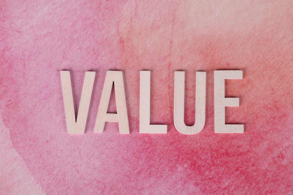The word 'VALUE' in bold letters on a textured pink background.